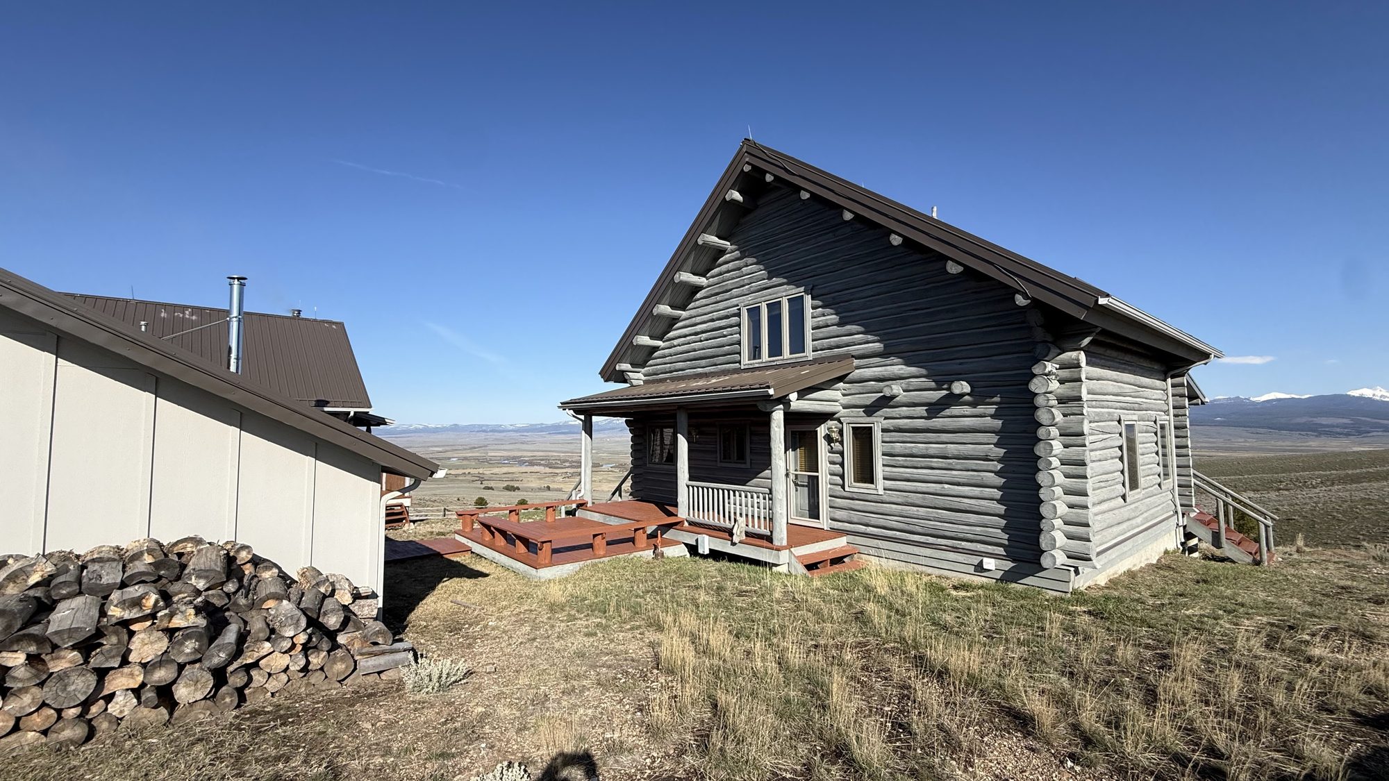 The Bunkhouse with the woodpile and mountain views