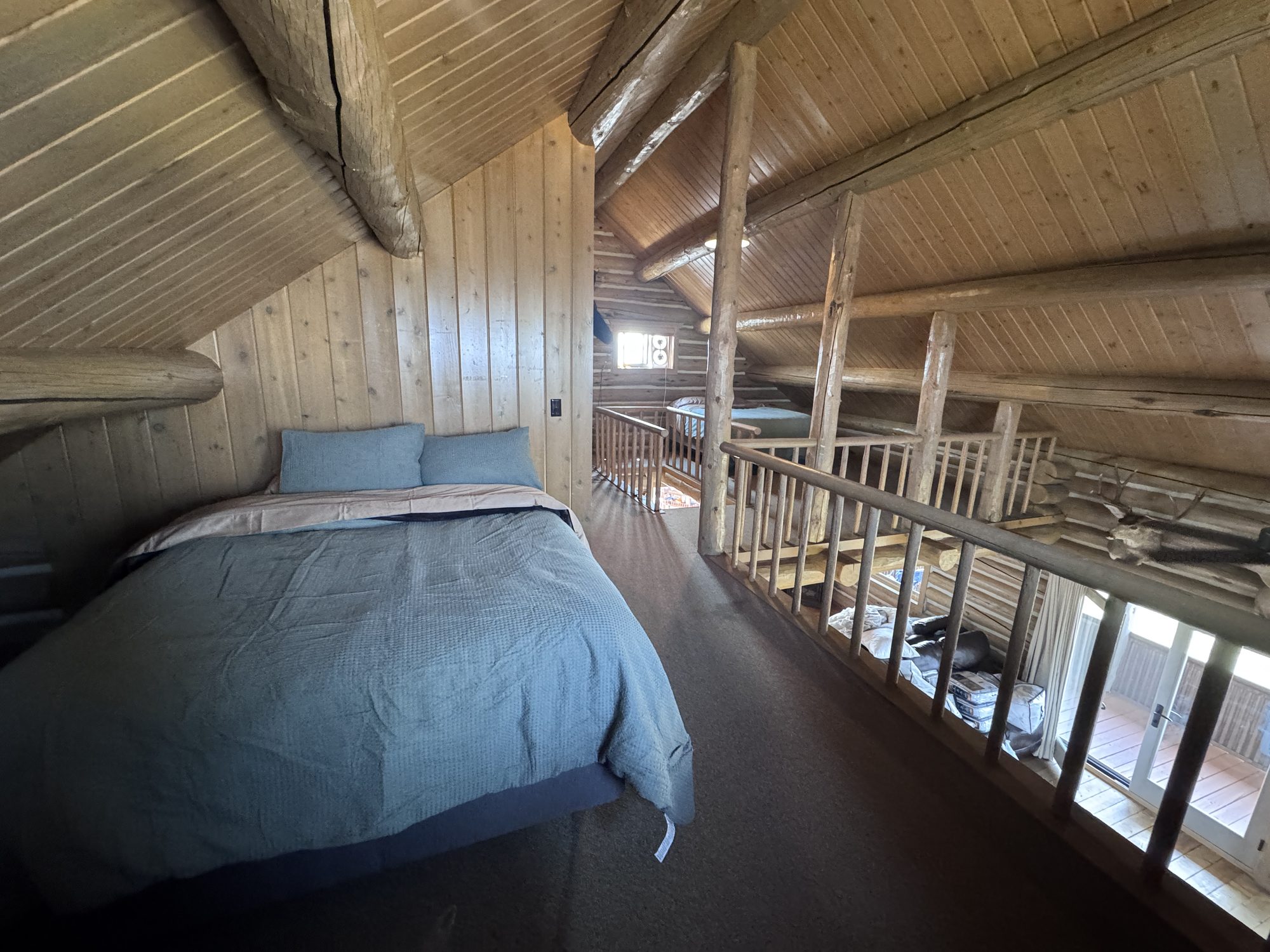 Sleeping loft — queen bed with the great room below